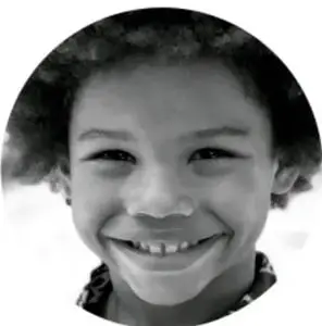 Fotografía en círculo de un niño sonriente a color con fondo blanco.