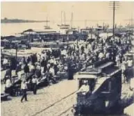 Fotografía histórica de un tranvía construido en Guayaquil entre 1905 y 1920, rodeado de personas y actividad urbana.