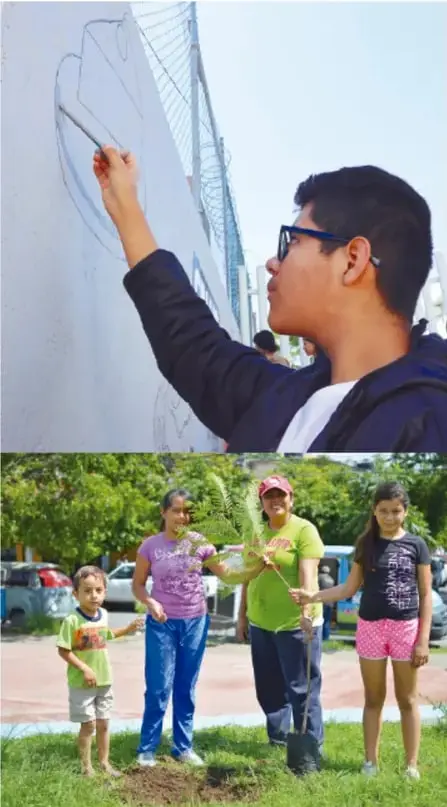 Estudiante con lentes dibujando o escribiendo con gis sobre una pared o pizarra al aire libre.