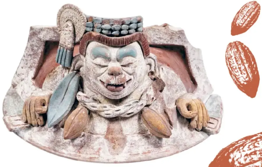 Figura de barro policromada (cerámica maya) de un personaje recostado con tocado, sandalias y granos de cacao; pie de foto: "Ek Chuah, dios maya del comercio y del cacao".