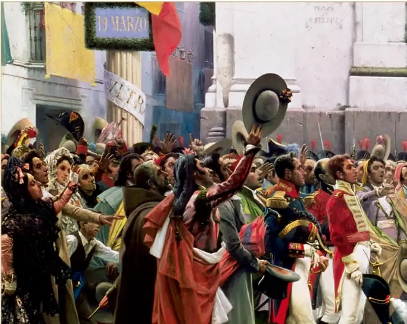 Pintura de una multitud celebrando en una plaza con banderas y un cartel que hace referencia al 19 de marzo, representando la proclamación de la Constitución de 1812 en Cádiz.