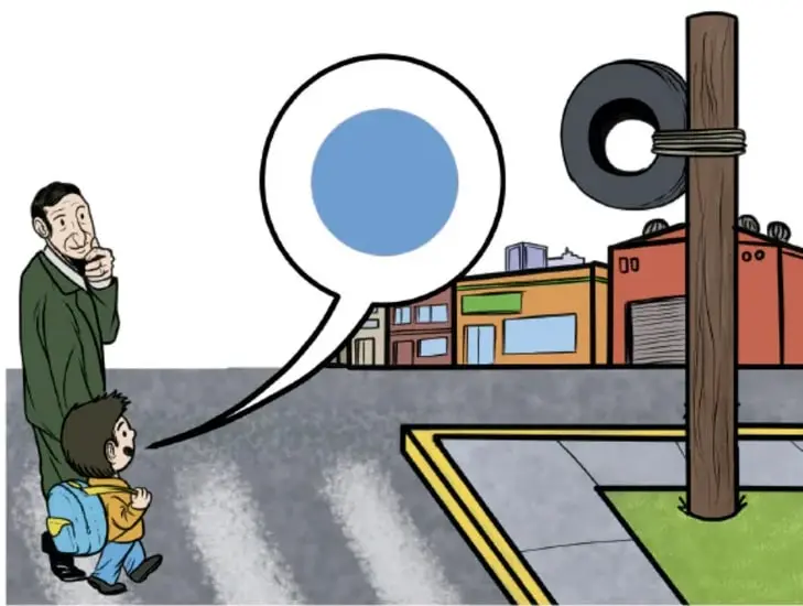 Un papá y su hijo con mochila esperan en una esquina; el niño dice "¡Veo, veo...!" en un bocadillo con una esfera azul y en el poste cuelga una llanta; al fondo hay tiendas y una banqueta. Ilustración de José Daniel Romero Gutiérrez, Ciudad de México.
