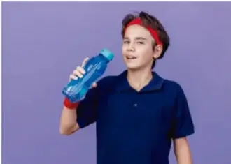 Joven con diadema roja y camiseta azul bebiendo de una botella de agua deportiva, ilustrando la reposición de líquidos.