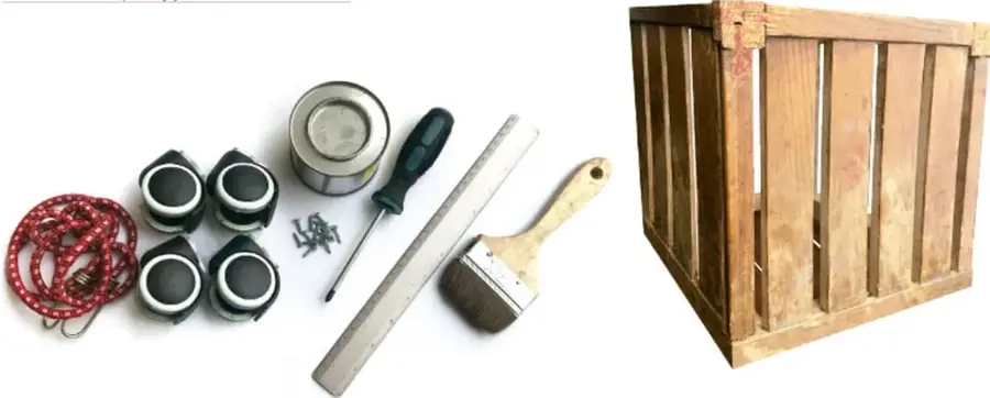 Fotografía de los materiales: lazo rojo, cuatro ruedas, bote de pintura, desarmador, regla metálica, brocha y tornillos, junto a un huacal de madera armado.