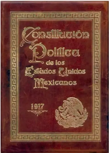 Portada de la Constitución Política de los Estados Unidos Mexicanos de 1917, con letras doradas y el Escudo Nacional sobre fondo rojo.