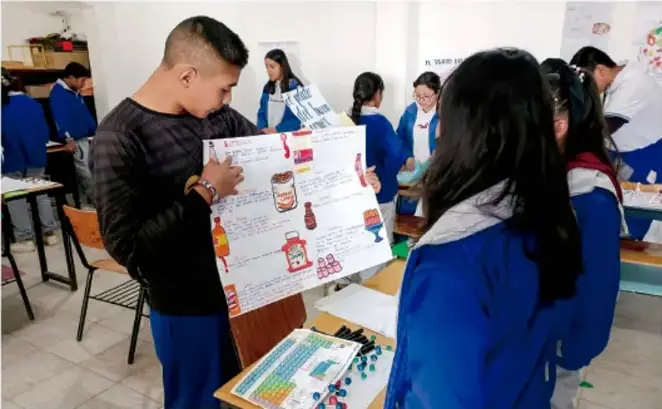 Fotografía de estudiantes de telesecundaria presentando carteles de proyecto en el aula. Crédito: Luis Eduardo García Medel, Tlaxcala.