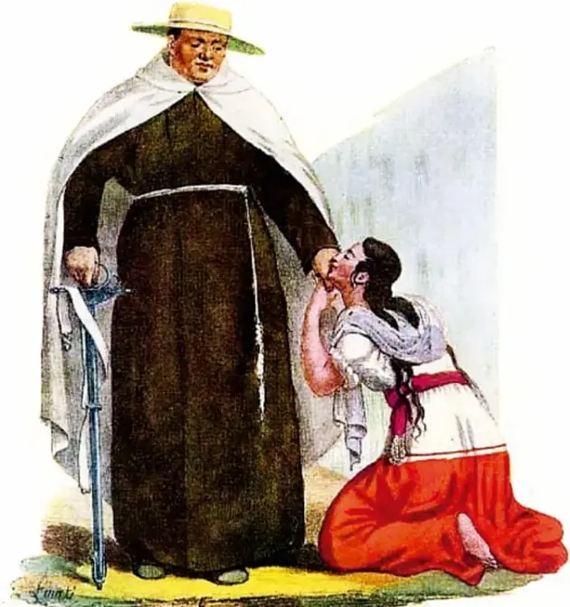 Litografía coloreada de Claudio Linati (1828), 'El carmelita Fray Gregorio': un fraile de hábito oscuro y capa blanca, con sombrero de ala ancha, de pie junto a una mujer arrodollada que le besa la mano; escena de devoción y jerarquía social en el México de 1828. Acervo INEHRM.