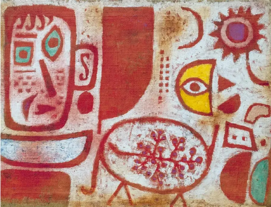 Reproducción de la obra *Intoxicación* (1939) de Paul Klee. Predominan los tonos rojos, ocres y amarillos. A la izquierda hay un rostro estilizado formado por un cuadrado grande con un rectángulo pequeño dentro, ojos circulares y triangulares. En el centro aparece una figura ovalada con un patrón de puntos rojos y líneas que parecen patas. A la derecha se observa un sol con centro circular y rayos triangulares, además de una pequeña casa formada por un cuadrado y un triángulo.