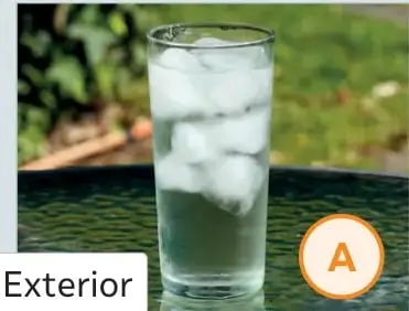 Vaso A con hielo en el exterior, sobre una mesa.