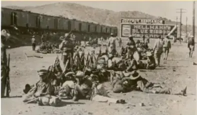 Fotografía histórica en blanco y negro que muestra a un grupo de personas, entre ellas niños, en un entorno rural o de campamento durante la Revolución Mexicana.