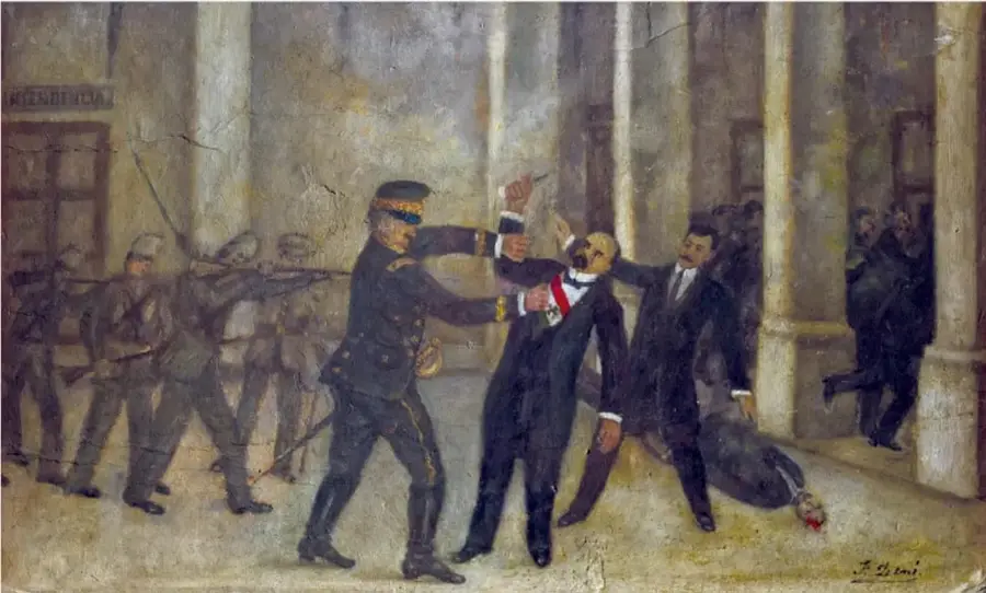 Pintura histórica que representa la aprehensión o ataque contra Francisco I. Madero en un patio con columnas; aparecen militares y civiles armados, uno de ellos con banda presidencial, y una persona caída en el suelo.