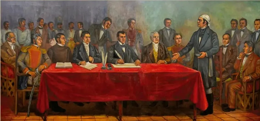 Pintura de Rafael Gallegos, 'Congreso de Apatzingán' (óleo sobre tela, ca. 1950): diputados reunidos alrededor de una mesa con manto rojo firmando el decreto, con Morelos de pie interviniendo.