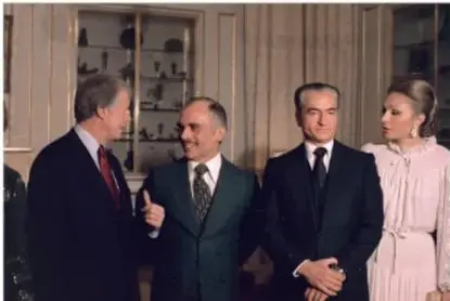 Fotografía de una reunión diplomática en la que aparecen varios hombres con traje y una mujer; uno de ellos es identificable como Reza Pahlevi.