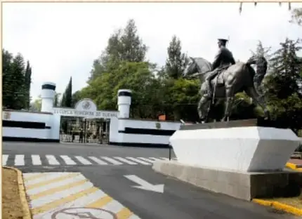 Fotografía de la entrada de la Escuela Superior de Guerra, con un monumento ecuestre y la fachada del plantel.