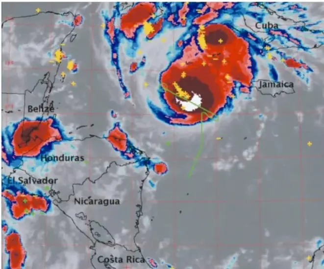 Imagen satelital del huracán tomada por GOES11; muestra nubes en rojo y azul, relámpagos en amarillo y la ruta del avión ER-2 en verde sobre el Caribe.