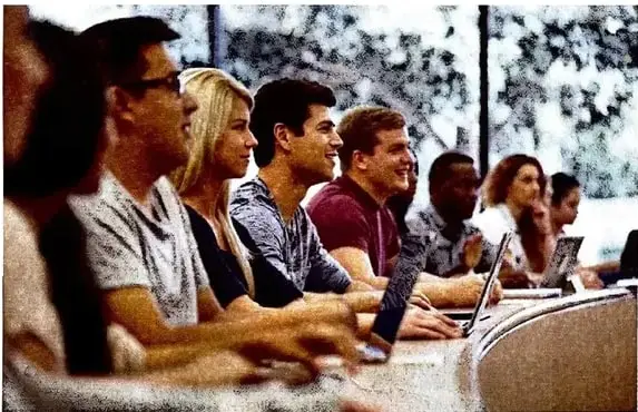 Fotografía de varias personas utilizando computadoras y otros dispositivos tecnológicos.