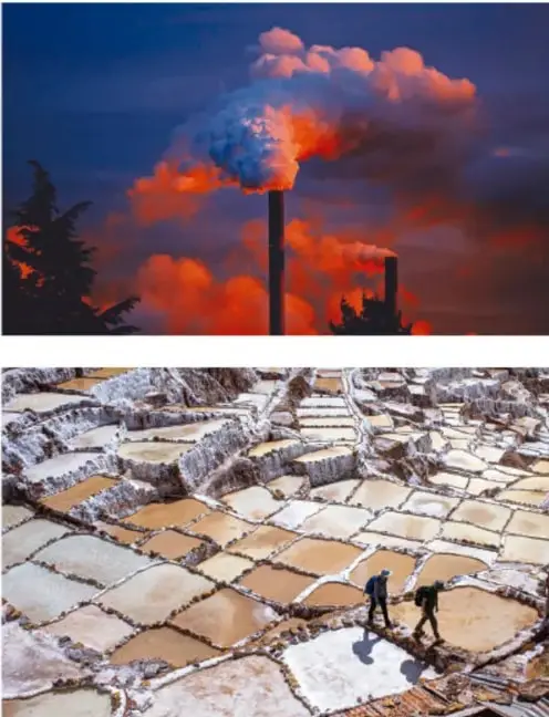 Chimeneas industriales emitiendo humo y nubes anaranjadas al atardecer, ilustrando reacciones de combustible y su impacto atmosférico.