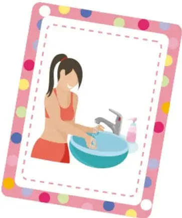 Tarjeta rosa con puntos de colores que muestra a un niño cepillándose los dientes.