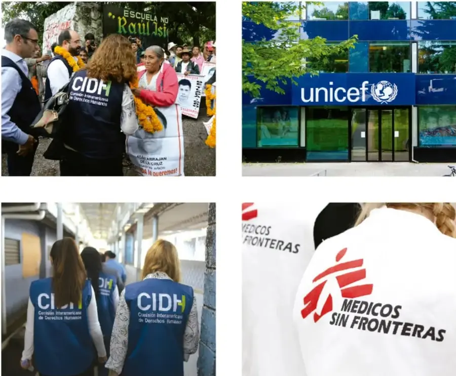 Personas en una marcha; una mujer con chaleco azul de la CIDH y carteles con la leyenda 'Escuela no Raúl Isidro'.