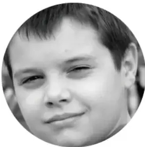 Fotografía de un niño sonriente con cabello corto.