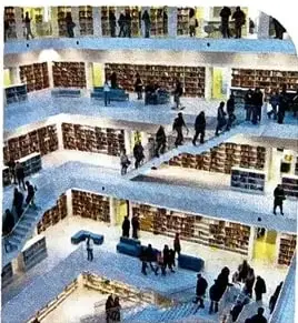 Interior de una biblioteca moderna con varios niveles y personas leyendo o caminando.