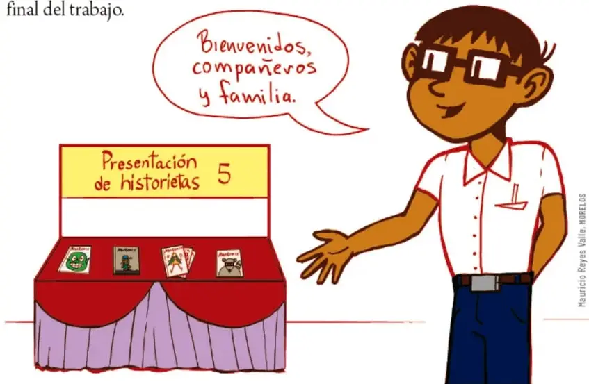 Estudiante con lentes y camisa blanca da la bienvenida con un globo de diálogo que dice 'Bienvenidos, compañeros y familia'. A su lado, una mesa exhibidora con el letrero 'Presentación de historietas 5' y varias historietas.
