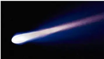Fotografía de un cometa con la cola brillante sobre fondo espacial oscuro.