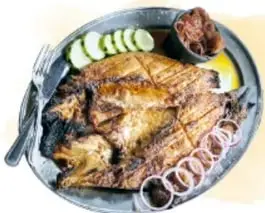 Fotografías de un pescado zarandeado con cebollas, un cabrito asado en las brasas y sopes verdes con chapulines sobre hoja de plátano.