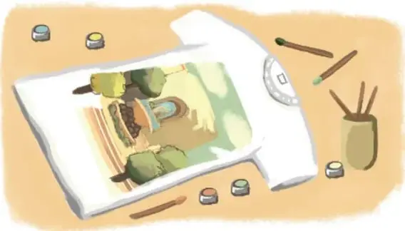 Playera blanca pintada con un paisaje y materiales de arte alrededor.