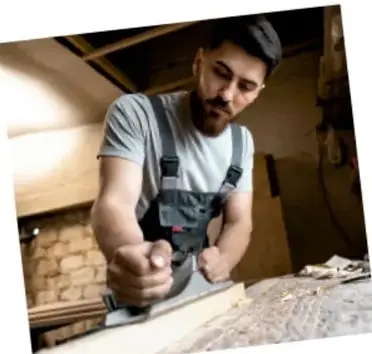Fotografía de un hombre trabajando la madera en un taller, como ejemplo de aprovechamiento maderable.