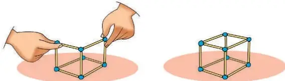 Manos armando una estructura cúbica con bolitas de plasticina en los vértices y palos de fósforo en las aristas.