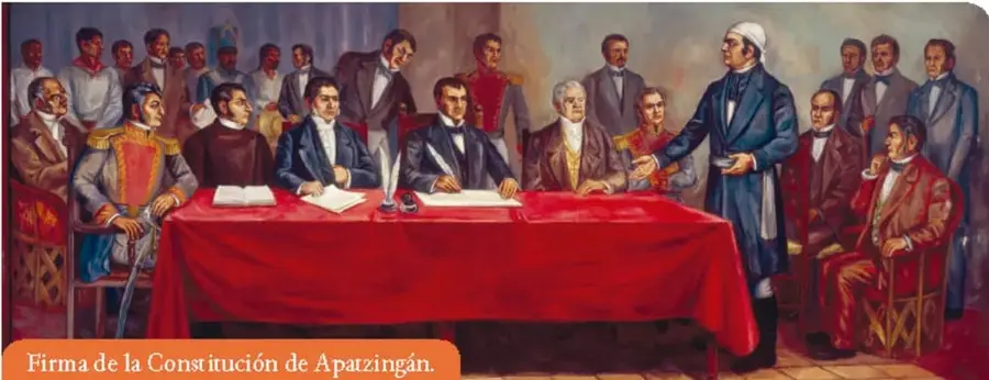 Pintura que representa la firma de la Constitución de Apatzingán, con varios personajes reunidos alrededor de una mesa cubierta con un mantel rojo.