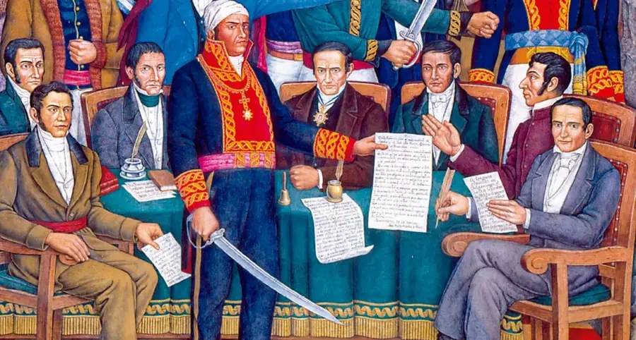 Detalle del mural Retablo de la Independencia de Juan O'Gorman: figuras masculinas de la Independencia, entre ellas Morelos de pie con espada, reunidas alrededor de una mesa con documentos y plumas.