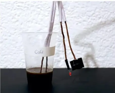Bandeja negra con vasos de plástico que contienen distintas sustancias sólidas en polvo (sal, azúcar, bicarbonato) y un biberón con agua destilada.