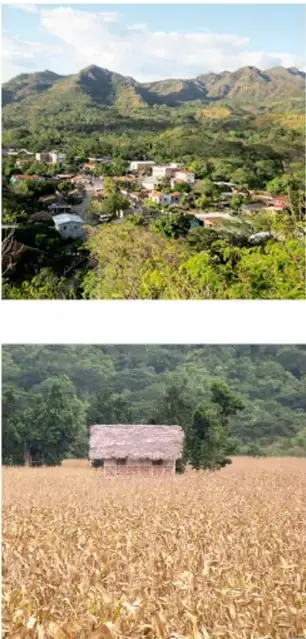 Paisaje rural con montañas, vegetación y casas dispersas.