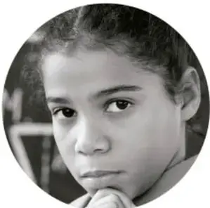 Fotografía en blanco y negro de una niña con expresión pensativa.