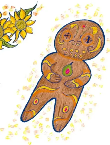 Figura de pan de muerto con forma de muñequito, decorado con glaseado, azúcar y una hoja verde sobre el pecho.