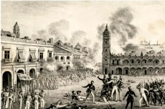 Grabado histórico en blanco y negro que muestra una escena de combate callejero con soldados y civiles armados frente a edificios coloniales, con humo de disparos; representa un episodio de la Guerra de Reforma o de la intervención extranjera.