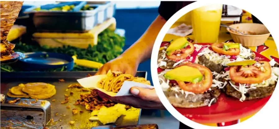 Puesto de comida mexicana: manos sirviendo tacos o antojitos sobre una hoja de papel, con tortillas y verduras en un comal.