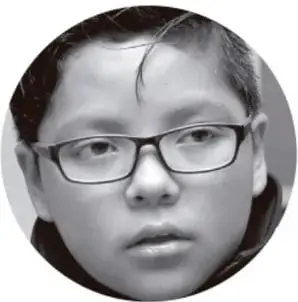 Fotografía en blanco y negro de un estudiante con lentes, mirando de frente.