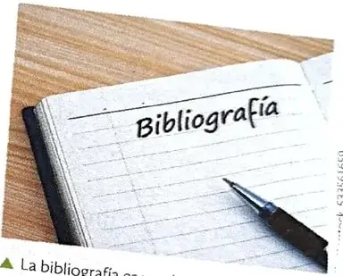 Cuaderno titulado Bibliografía junto a un bolígrafo, que representa la elaboración de referencias.
