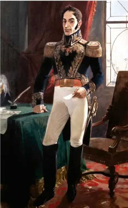 Retrato de cuerpo entero de Simón Bolívar con uniforme militar de gala, de pie junto a una mesa con documentos y una pluma.
