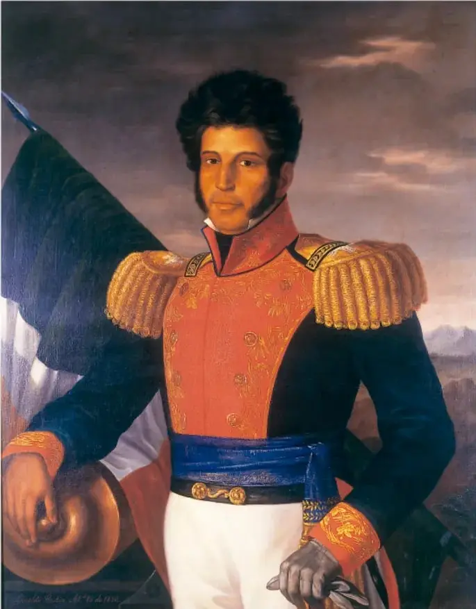 Retrato pictórico de Vicente Guerrero con uniforme militar rojo y dorado de gala, charreteras doradas, fajín azul y la bandera mexicana detrás.