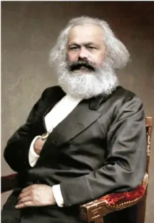 Retrato fotográfico de Karl Marx, filósofo y economista alemán, con barba y traje oscuro.