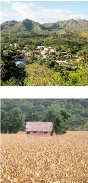 Vista de un poblado rural entre montañas verdes con viviendas dispersas.