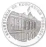 Fotografía del reverso de una medalla circular conmemorativa con leyenda y edificio representado.