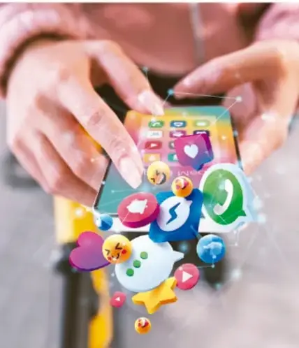 Fotografía de unas manos sosteniendo un celular desde el cual emergen iconos de aplicaciones y redes sociales (mensajes, megáfono, estrella, corazón, chat), representando la conexión digital y la transmisión de información.