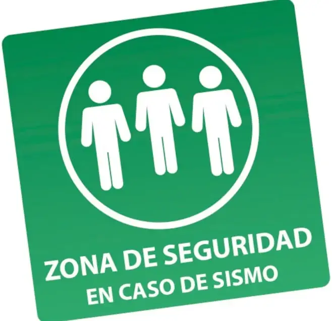 Señal verde cuadrada con tres figuras humanas blancas dentro de un círculo y el texto 'ZONA DE SEGURIDAD EN CASO DE SISMO'.