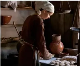 Ilustración de una mujer cocinando en un entorno rural, asociada a la Edad Media.